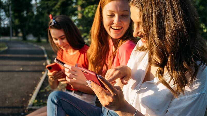 group of girls looking at phone