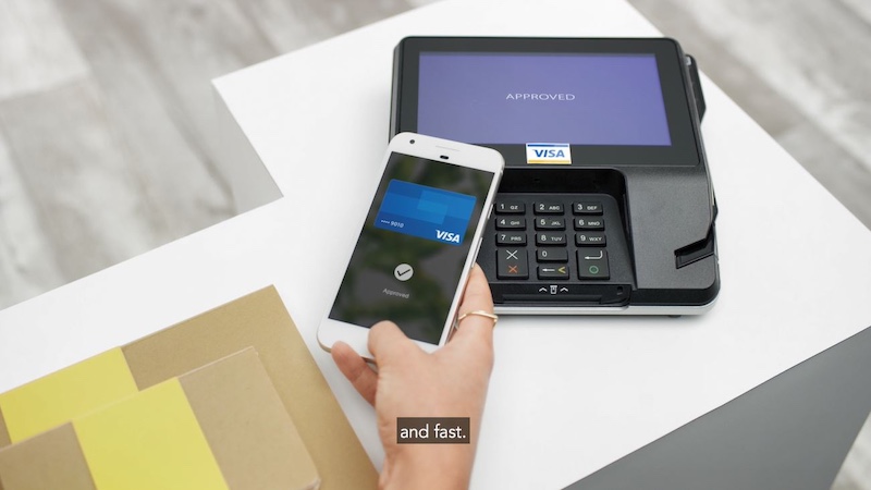 Hand holding a mobile phone , tapping mobile contactless Visa credit card on a payment terminal. Caption that says : and fast.